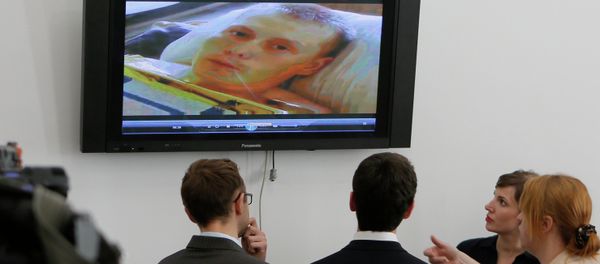 Reporters look at the TV screen showing Alexander Alexandrov, a Russian ex-soldier captured by the Ukrainian military in the Luhansk region last month. - Sputnik International