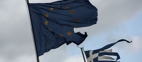 Ruined EU and Greek flags fly in tatters from a flag pole at a beach at Anavissos village, southwest of Athens, on Monday, March 16, 2015 - Sputnik International