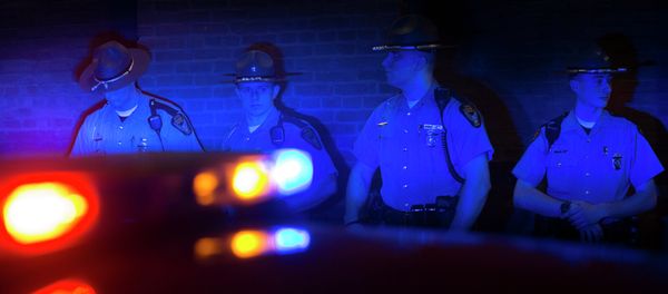 Police officers are illuminated by patrol car lights during a protest against the acquittal of Michael Brelo, a patrolman charged in the shooting deaths of two unarmed suspects. Police officers are illuminated by patrol car lights during a protest against the acquittal of Michael Brelo, a patrolman charged in the shooting deaths of two unarmed suspects. - Sputnik International