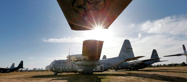 Numerous C-130 cargo planes are lined up in a field at the 309th Aerospace Maintenance and Regeneration Group boneyard at Davis-Monthan Air Force Base in Tucson, Ariz - Sputnik International