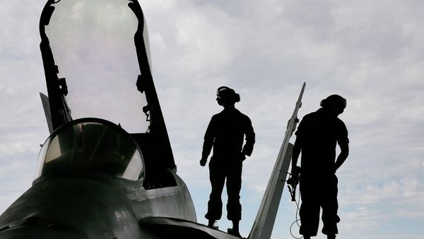 US Marines work atop an F/A-18 at the 309th Aerospace Maintenance and Regeneration Group boneyard in Tucson, Ariz - Sputnik International