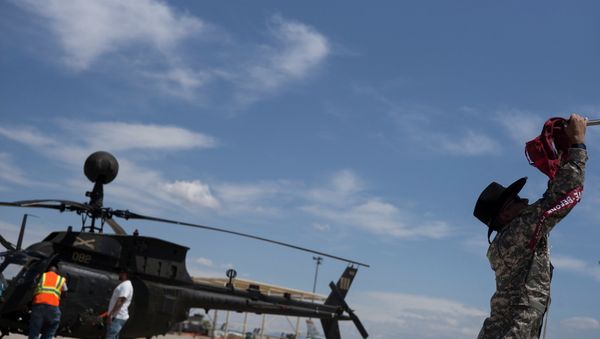 A soldier secures the rotor blades of his Bell OH-58 Kiowa helicopter while dropping it off to be stored at the boneyard at the Aerospace Maintenance and Regeneration Group on Davis-Monthan Air Force Base in Tucson, Arizona - Sputnik International