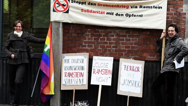 Protestors hold a banner reading Stop the drone war via Ramstein, solidarity with the victims - Sputnik International