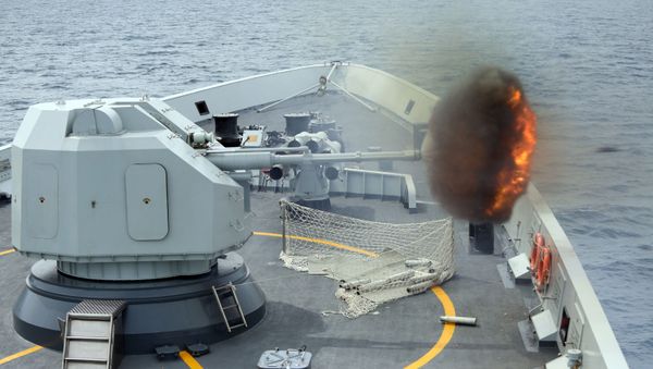 In this Sunday, May 24, 2015 photo released by China's Xinhua News Agency, an anti-surface gunnery is fired from China's Navy missile frigate Yulin during the Exercise Maritime Cooperation 2015 by Singapore and Chinese navies in the South China Sea In this Sunday, May 24, 2015 photo released by China's Xinhua News Agency, an anti-surface gunnery is fired from China's Navy missile frigate Yulin during the Exercise Maritime Cooperation 2015 by Singapore and Chinese navies in the South China Sea - Sputnik International