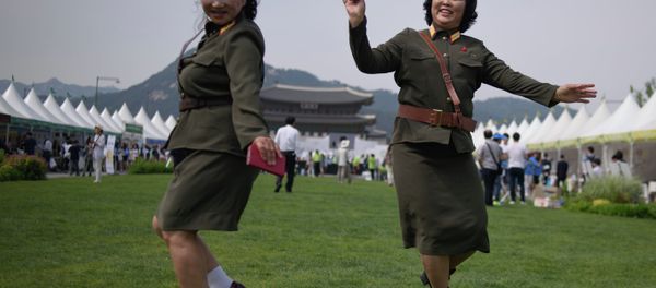 North Korean defectors wearing North Korean military uniforms dance in Gwanghwamun square during a 'unification expo' in central Seoul on May 29, 2015 - Sputnik International