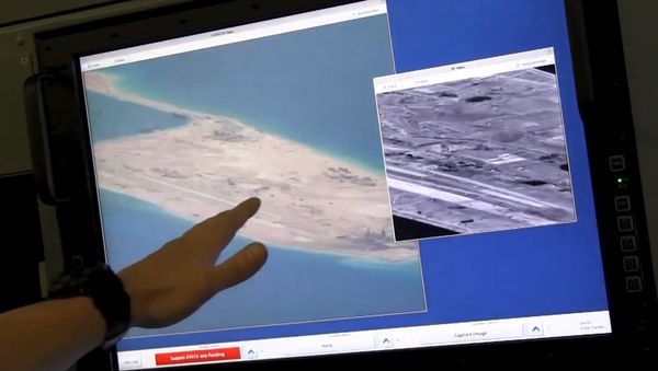 US Navy crewman aboard a P-8A Poseidon surveillance aircraft points to a computer screen purportedly showing Chinese construction on the reclaimed land of Fiery Cross Reef in the disputed Spratly Islands in the South China Sea in this still image from video provided by the United States Navy May 21, 2015 US Navy crewman aboard a P-8A Poseidon surveillance aircraft points to a computer screen purportedly showing Chinese construction on the reclaimed land of Fiery Cross Reef in the disputed Spratly Islands in the South China Sea in this still image from video provided by the United States Navy May 21, 2015 - Sputnik International