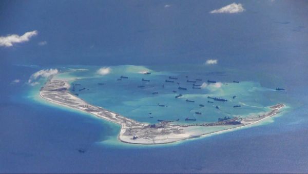 Chinese dredging vessels are purportedly seen in the waters around Mischief Reef in the disputed Spratly Islands in the South China Sea, in this file still image from video taken by a P-8A Poseidon surveillance aircraft and provided by the United States Navy on May 21, 2015 - Sputnik International