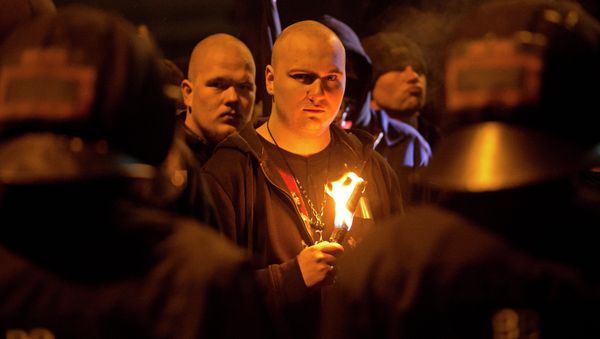 A neo-Nazi surrounded by riot police holds a torch during a rally to commemorate the 68nd anniversary of the bombing of Dresden A neo-Nazi surrounded by riot police holds a torch during a rally to commemorate the 68nd anniversary of the bombing of Dresden - Sputnik International