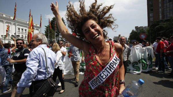 A woman dances while protesting in front of the Government building in Skopje, Macedonia A woman dances while protesting in front of the Government building in Skopje, Macedonia - Sputnik International
