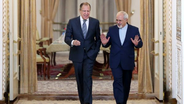 Iranian Foreign Minister Mohammad Javad Zarif, right, and his Russian counterpart Sergey Lavrov arrive to their joint press conference in Tehran, Iran Iranian Foreign Minister Mohammad Javad Zarif, right, and his Russian counterpart Sergey Lavrov arrive to their joint press conference in Tehran, Iran - Sputnik International