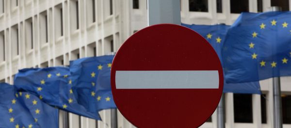 In this photo taken on Monday, March 30, 2015 EU flags flap in the wind behind a no entry traffic sign in front of EU headquarters in Brussels - Sputnik International