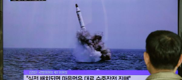 A South Korean man watches a TV news program showing an image published in North Korea's Rodong Sinmun newspaper of North Korea's ballistic missile believed to have been launched from underwater, at Seoul Railway station in Seoul, South Korea, Saturday, May 9, 2015 A South Korean man watches a TV news program showing an image published in North Korea's Rodong Sinmun newspaper of North Korea's ballistic missile believed to have been launched from underwater, at Seoul Railway station in Seoul, South Korea, Saturday, May 9, 2015 - Sputnik International