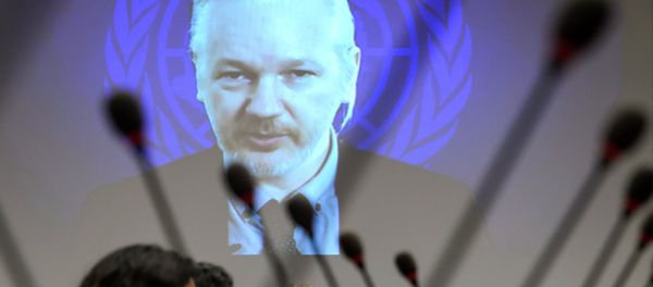 WikiLeaks founder Julian Assange is seen on a screen speaking via web cast from the Ecuadorian Embassy in London during an event on the sideline of the United Nations (UN) Human Rights Council session - Sputnik International