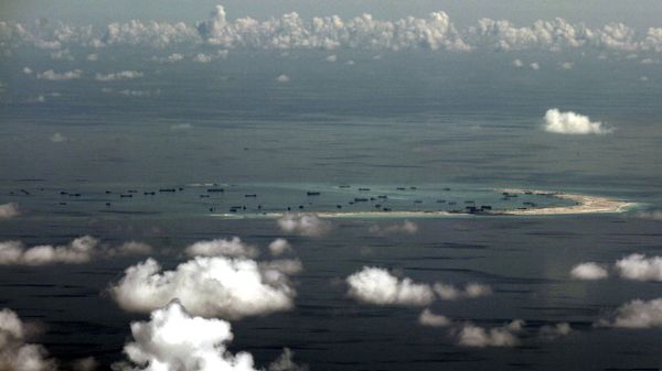 An aerial file photo taken though a glass window of a Philippine military plane shows the alleged land reclamation by China on Mischief Reef in the Spratly Islands in the South China Sea, west of Palawan, Philippines, May 11, 2015 - Sputnik International