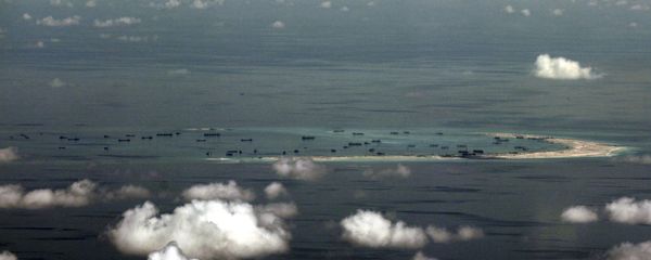 An aerial file photo taken though a glass window of a Philippine military plane shows the alleged land reclamation by China on Mischief Reef in the Spratly Islands in the South China Sea, west of Palawan, Philippines, May 11, 2015 - Sputnik International