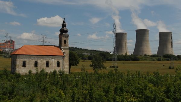 Steam cooling towers of the Mochovce nuclear power plant release steam behind a small church Steam cooling towers of the Mochovce nuclear power plant release steam behind a small church - Sputnik International