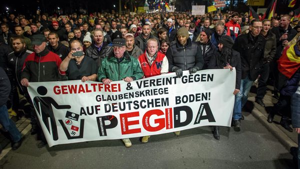 A picture taken on December 15, 2014 shows supporters of the PEGIDA movement, Patriotische Europaeer gegen die Islamisierung des Abendlandes, which translates to Patriotic Europeans Against the Islamification of the Occident, taking part in a rally in Dresden, eastern Germany. File photo A picture taken on December 15, 2014 shows supporters of the PEGIDA movement, Patriotische Europaeer gegen die Islamisierung des Abendlandes, which translates to Patriotic Europeans Against the Islamification of the Occident, taking part in a rally in Dresden, eastern Germany. File photo - Sputnik International