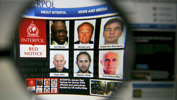 The homepage of the Interpol website is seen through a magnifying glass in this picture illustration taken in Berlin, Germany June 3, 2015 - Sputnik International