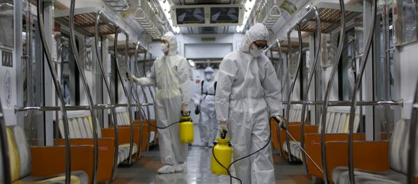 Workers in full protective gear disinfect the interior of a subway train at a Seoul Metro's railway vehicle base in Goyang, South Korea, June 9, 2015 - Sputnik International