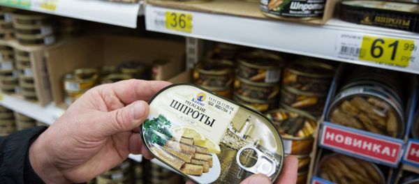 A customer chooses canned sprats in a Moscow supermarket A customer chooses canned sprats in a Moscow supermarket - Sputnik International