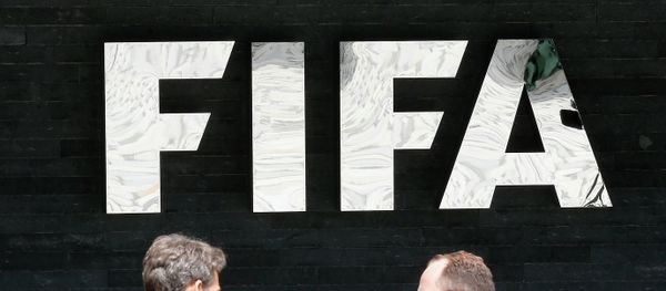 Two men talk to each other in front of the FIFA logo at the FIFA headquarters in Zurich, Switzerland, Wednesday, May 27, 2015 Two men talk to each other in front of the FIFA logo at the FIFA headquarters in Zurich, Switzerland, Wednesday, May 27, 2015 - Sputnik International