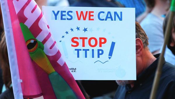 Demonstrators hold a sign against the TTIP contract during a protest Demonstrators hold a sign against the TTIP contract during a protest - Sputnik International