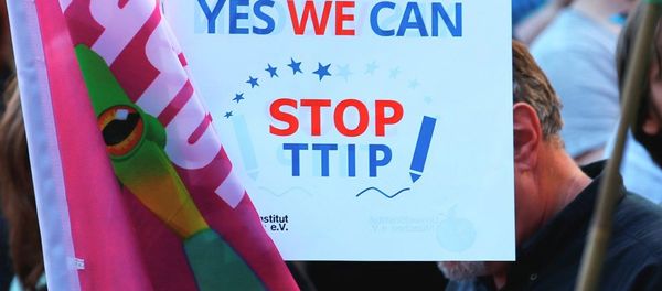 Demonstrators hold a sign against the TTIP contract during a protest Demonstrators hold a sign against the TTIP contract during a protest - Sputnik International