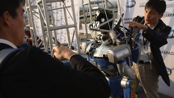 Roboticists take a closer look at the KAWADA Industries HRP-2 humanoid robot during the first day of the Defense Advanced Research Projects Agency (DARPA) Robotics Challenge at the Fairplex June 5, 2015 in Pomona, California Roboticists take a closer look at the KAWADA Industries HRP-2 humanoid robot during the first day of the Defense Advanced Research Projects Agency (DARPA) Robotics Challenge at the Fairplex June 5, 2015 in Pomona, California - Sputnik International