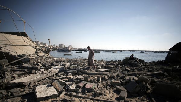 A Palestinian man inspects the damage of a police post, following an Israeli missile strike killing four boys from the same extended Bakr family, in Gaza City, Wednesday, July 16, 2014. - Sputnik International