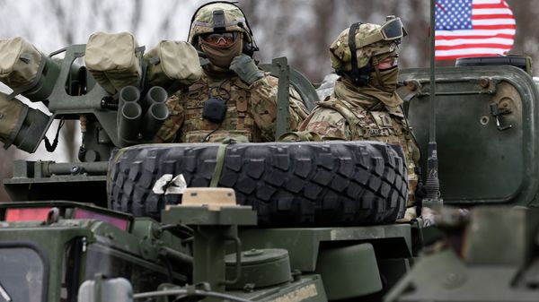 Members of US Army’s 2nd Cavalry Regiment ride on an armored vehicle Members of US Army’s 2nd Cavalry Regiment ride on an armored vehicle - Sputnik International