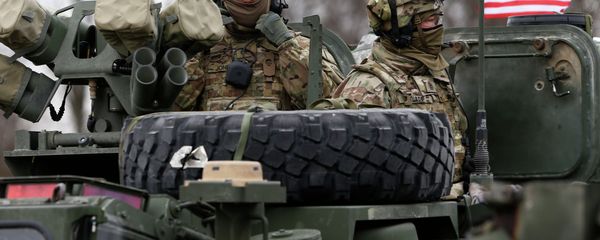 Members of US Army’s 2nd Cavalry Regiment ride on an armored vehicle - Sputnik International