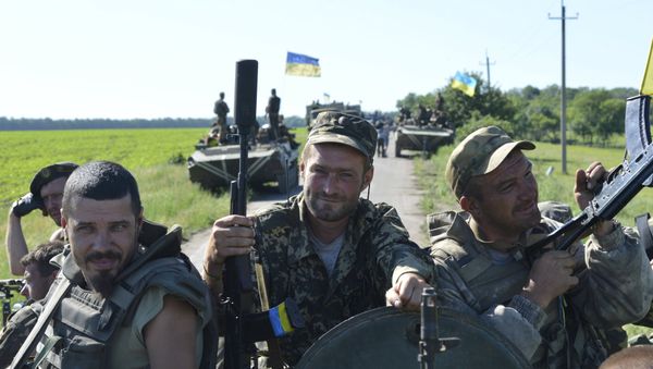 Members of the Ukrainian armed forces pose for a picture as they gather on an armoured vehicle on the roadside near the village of Vidrodzhennya outside Artemivsk, Donetsk region, Ukraine, June 9, 2015 Members of the Ukrainian armed forces pose for a picture as they gather on an armoured vehicle on the roadside near the village of Vidrodzhennya outside Artemivsk, Donetsk region, Ukraine, June 9, 2015 - Sputnik International
