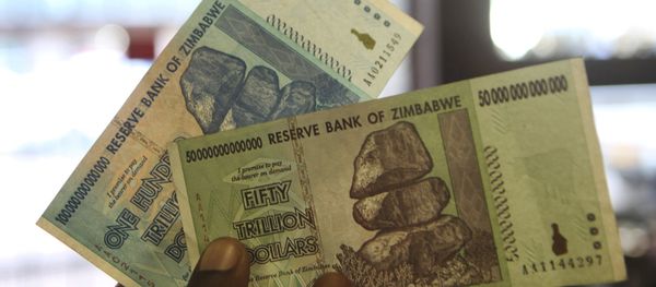 A man holds up for a picture a one hundred and an a fifty trillion Zimbabwean dollars notes inside a shop in Harare, Zimbawe, June 12, 2015 A man holds up for a picture a one hundred and an a fifty trillion Zimbabwean dollars notes inside a shop in Harare, Zimbawe, June 12, 2015 - Sputnik International