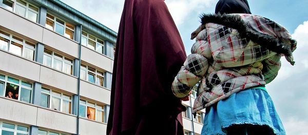 A woman and her child stand in front of the reception center for refugees in Schneeberg, eastern Germany. A woman and her child stand in front of the reception center for refugees in Schneeberg, eastern Germany. - Sputnik International