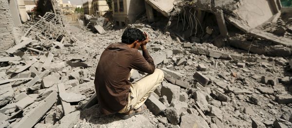 A guard sits on the rubble of the house of Brigadier Fouad al-Emad, an army commander loyal to the Houthis, after air strikes destroyed it in Sanaa, Yemen June 15, 2015 - Sputnik International