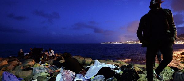 Migrants sleep on the rocks by the sea in Ventimiglia, at the border between Italy and France, early Monday, June 15, 2015 Migrants sleep on the rocks by the sea in Ventimiglia, at the border between Italy and France, early Monday, June 15, 2015 - Sputnik International