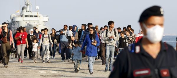 Syrian refugees are escorted by Carabinieri after disembarking from Belgian Navy vessel Godetia at the Augusta port, Italy, June 10, 2015 Syrian refugees are escorted by Carabinieri after disembarking from Belgian Navy vessel Godetia at the Augusta port, Italy, June 10, 2015 - Sputnik International