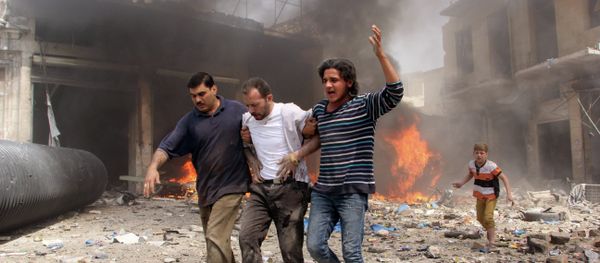 Syrian men help an injured person following a reported barrel bomb attack by Syrian government forces that hit an open market in the northern city of Aleppo, on June 3, 2015, killing and injuring people Syrian men help an injured person following a reported barrel bomb attack by Syrian government forces that hit an open market in the northern city of Aleppo, on June 3, 2015, killing and injuring people - Sputnik International