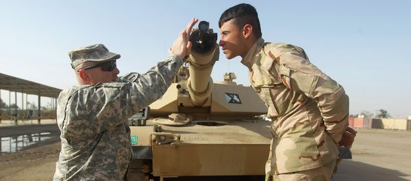 American military trainer shows an Iraqi soldier how to use a collimator to calibrate the gun barrel of an Abrams tank during a training session at the Taji base complex, which hosts Iraqi and US troops American military trainer shows an Iraqi soldier how to use a collimator to calibrate the gun barrel of an Abrams tank during a training session at the Taji base complex, which hosts Iraqi and US troops - Sputnik International