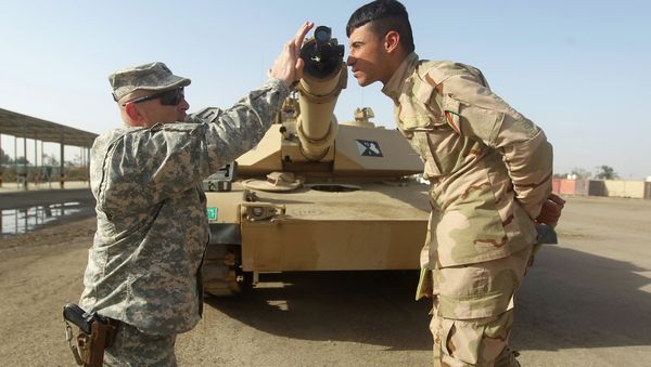American military trainer shows an Iraqi soldier how to use a collimator to calibrate the gun barrel of an Abrams tank during a training session at the Taji base complex, which hosts Iraqi and US troops American military trainer shows an Iraqi soldier how to use a collimator to calibrate the gun barrel of an Abrams tank during a training session at the Taji base complex, which hosts Iraqi and US troops - Sputnik International