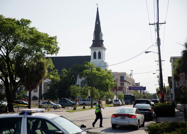 The steeple of Emanuel AME Church rises above the street as a police officer tells a car to move as the area is closed off following Wednesday's shooting, Thursday, June 18, 2015 in Charleston, S.C. The steeple of Emanuel AME Church rises above the street as a police officer tells a car to move as the area is closed off following Wednesday's shooting, Thursday, June 18, 2015 in Charleston, S.C. - Sputnik International