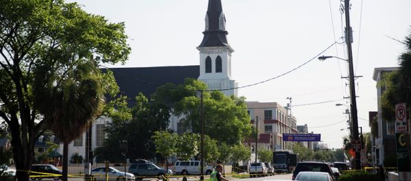 The steeple of Emanuel AME Church rises above the street as a police officer tells a car to move as the area is closed off following Wednesday's shooting, Thursday, June 18, 2015 in Charleston, S.C. - Sputnik International