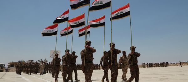 Sunni tribal volunteers with national flags march during their graduation ceremony. Sunni tribal volunteers with national flags march during their graduation ceremony. - Sputnik International