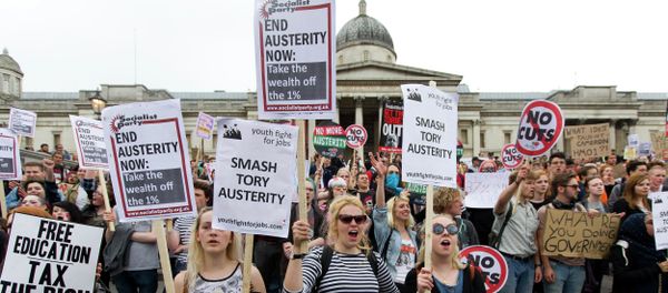 Protestors hold placards as they listen to speeches during an anti-austerity demonstration in London Protestors hold placards as they listen to speeches during an anti-austerity demonstration in London - Sputnik International