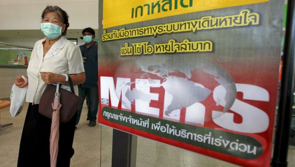 A woman wearing a mask walks past an information banner on Middle East Respiratory Syndrome (MERS) at the entrance of Bamrasnaradura Infectious Diseases Institute at a hospital in Nonthaburi province, on the outskirts of Bangkok, Thailand, June 19, 2015 - Sputnik International