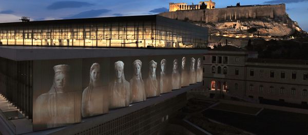 A projection depicting core-women statues is seen under the Parthenon hall on the new Acropolis museum building - Sputnik International