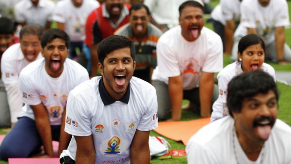 Indians perform yoga at an event to celebrate the International Yoga Day Indians perform yoga at an event to celebrate the International Yoga Day - Sputnik International