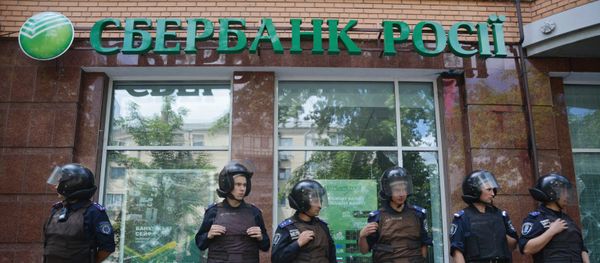 Sberbank of Russia branch in Kiev surrounded by Ukrainian police following vandalism by unidentified radicals. File photo. Sberbank of Russia branch in Kiev surrounded by Ukrainian police following vandalism by unidentified radicals. File photo. - Sputnik International