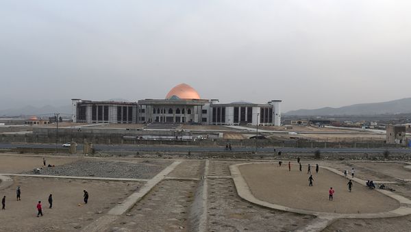 Afghan men play football as construction takes place of a new Parliament building in Kabul on February 10, 2015 - Sputnik International