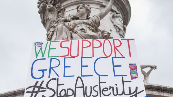 A man holds up a sign reading We support Greece #StopAusterity at the Republique Square during a demonstration against austerity in support of the Greek population in Paris, France, Saturday, June 20, 2015. A man holds up a sign reading We support Greece #StopAusterity at the Republique Square during a demonstration against austerity in support of the Greek population in Paris, France, Saturday, June 20, 2015. - Sputnik International
